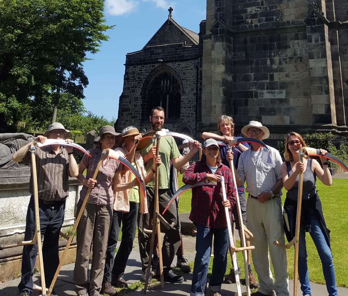 Volunteers with Scythes Outside Church