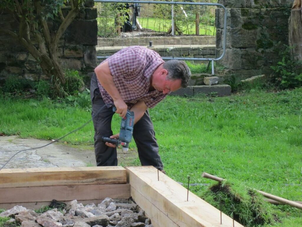 Using a drill above the beds 