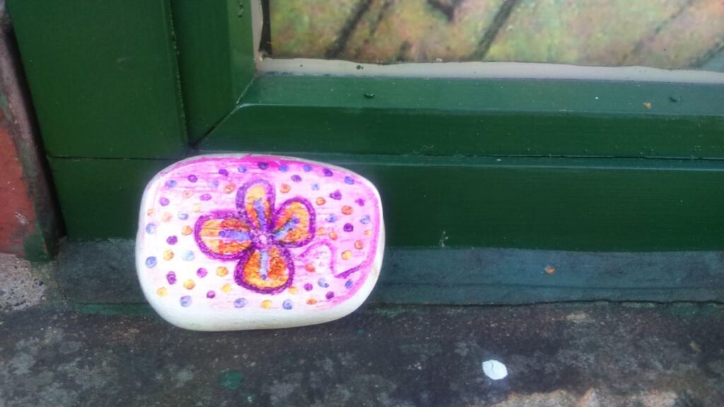 One of the painted stones left on the Triangle over the last year