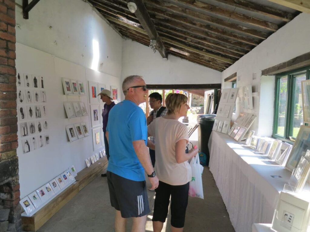 People viewing the art exhibition at the Triangle