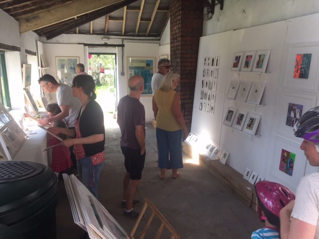 People viewing the art exhibition at the Triangle