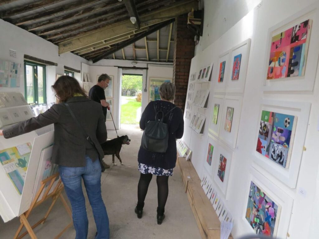 People viewing the art exhibition at the Triangle