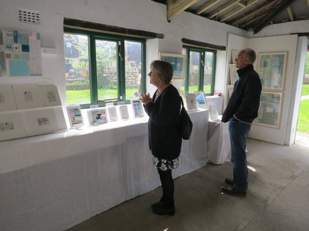 People viewing the art exhibition at the Triangle