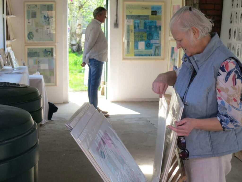 People viewing the art exhibition at the Triangle