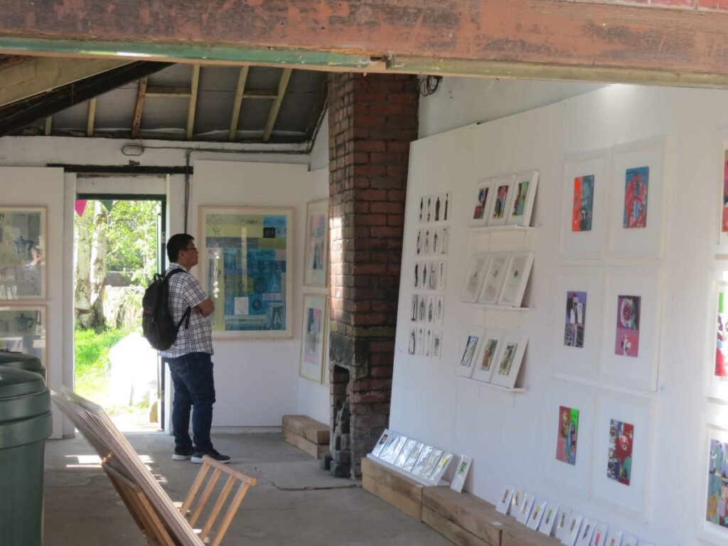 People viewing the art exhibition at the Triangle