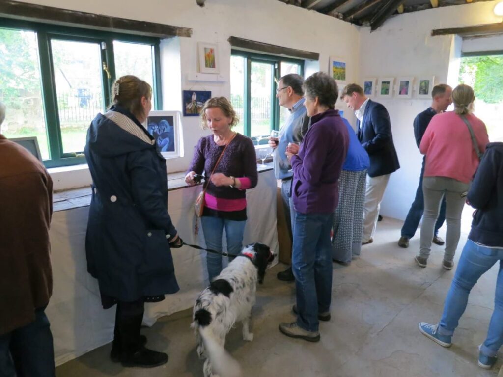 People attending the art exhibition at the Triangle