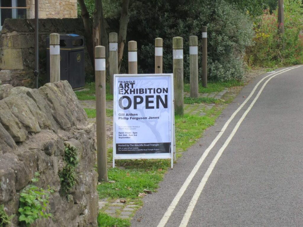 Sign promoting the art exhibition at the Triangle