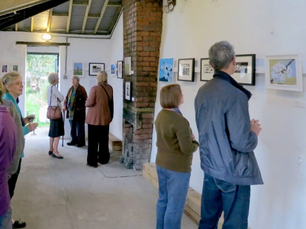 People attending the art exhibition at the Triangle