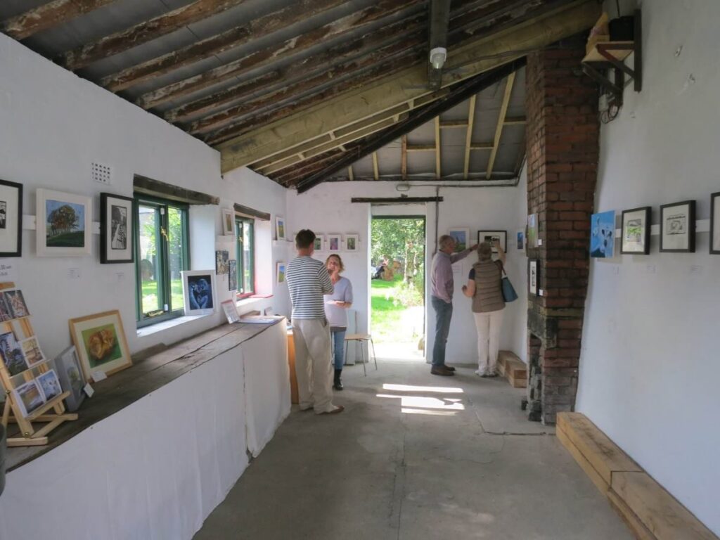 People attending the art exhibition at the Triangle