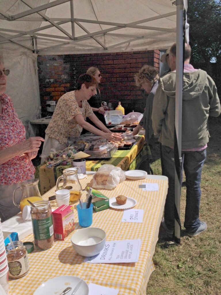 People attending the stalls, treasure trail and BBQ at the Triangle in the sunshine