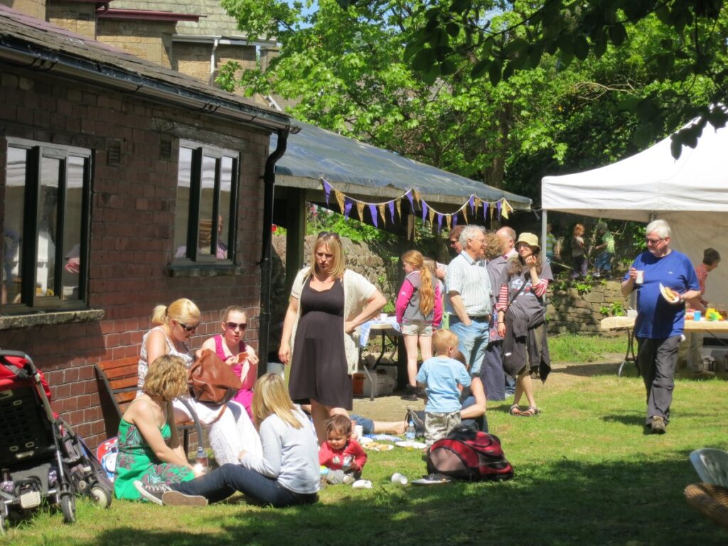 People attending the stalls, treasure trail and BBQ at the Triangle in the sunshine