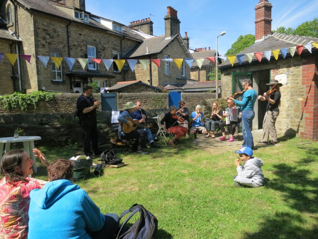 People attending the stalls, treasure trail and BBQ at the Triangle in the sunshine