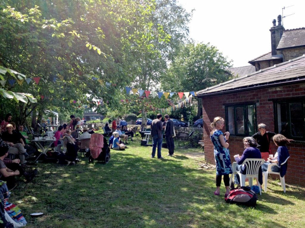 People attending the stalls, treasure trail and BBQ at the Triangle in the sunshine