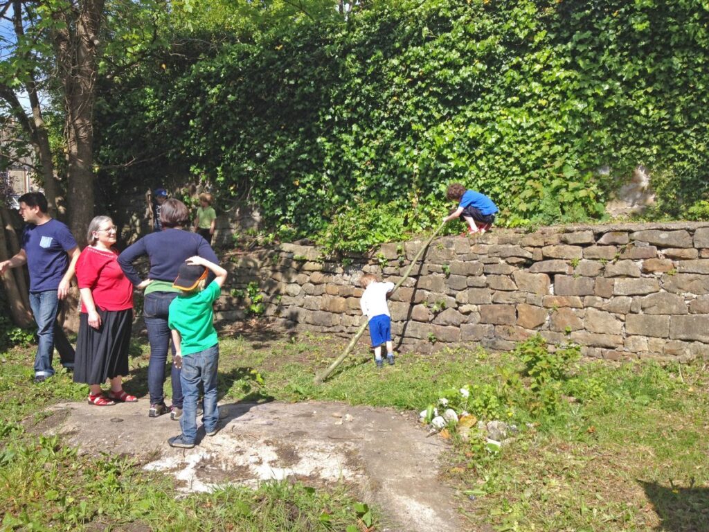 People attending the stalls, treasure trail and BBQ at the Triangle in the sunshine