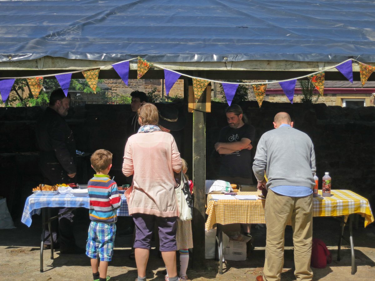 People attending the stalls, treasure trail and BBQ at the Triangle in the sunshine