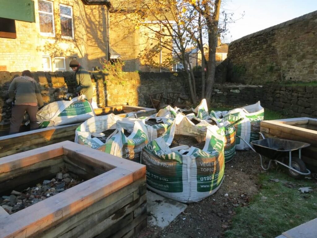 Working on the paths, ground and raised beds