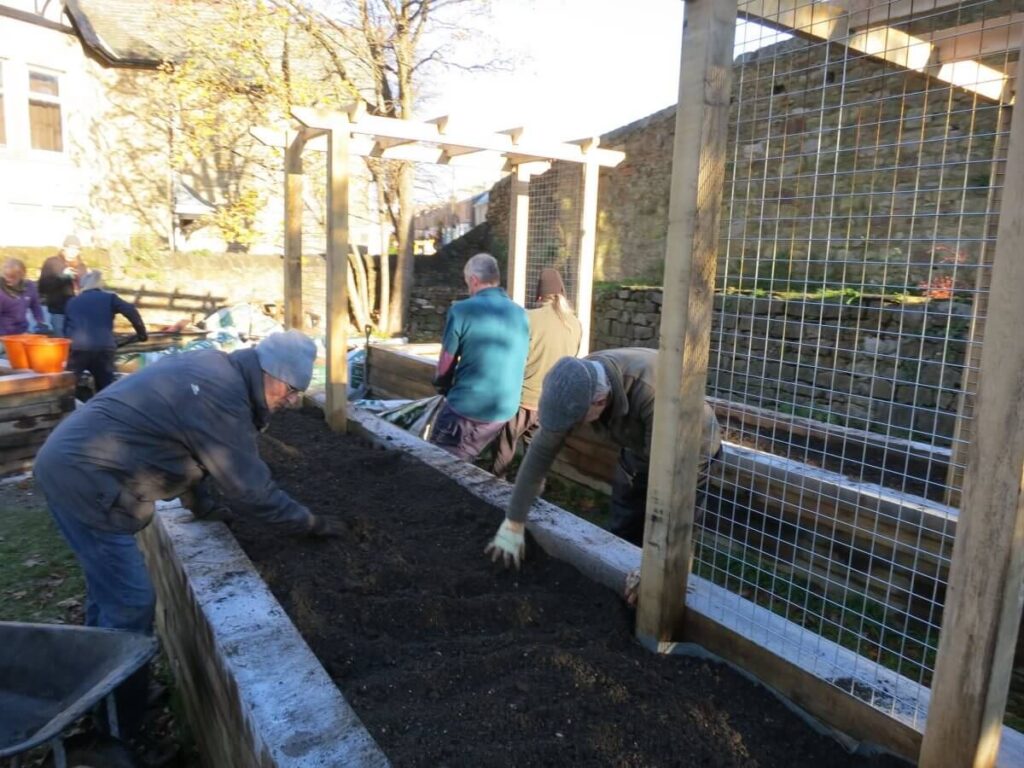 Working on the paths, ground and raised beds