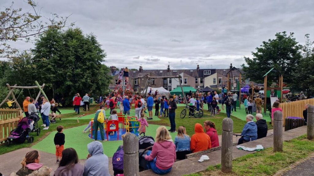 People at the playground opening July 2024