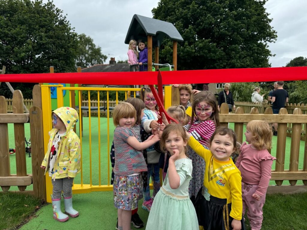 Children at the playground opening July 2024